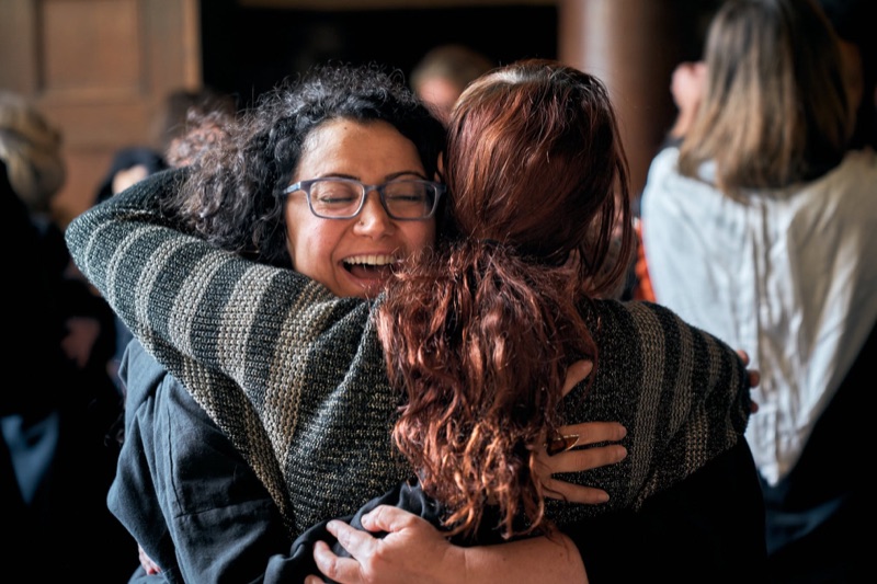 Two participants embracing at the College