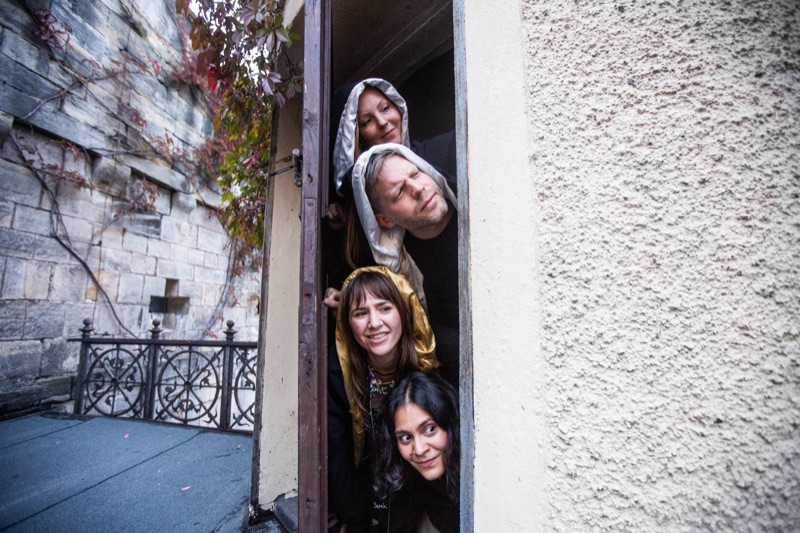 Participants leaning out from a castle doorway