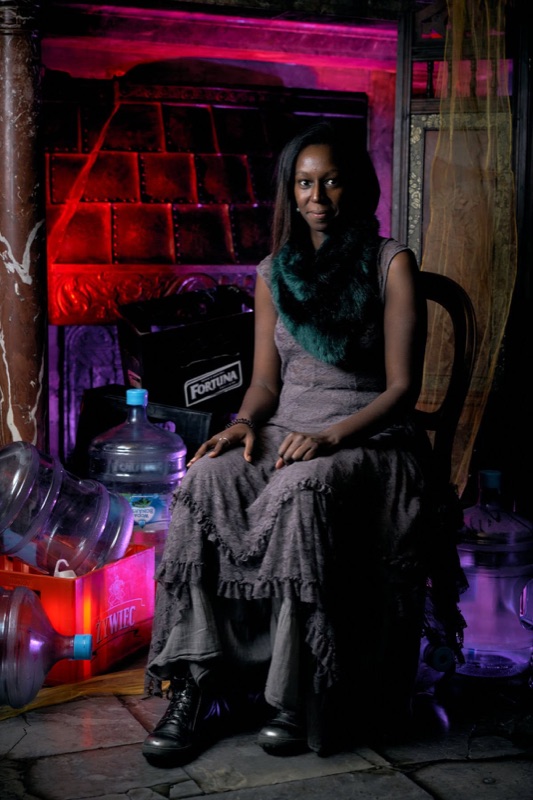 A participant in a purple-lit castle room