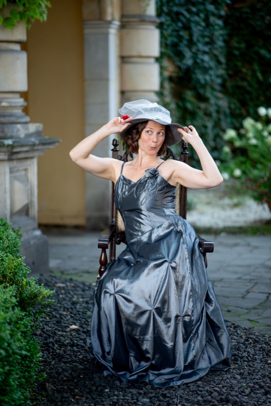 A participant playfully lifting a silver skirt