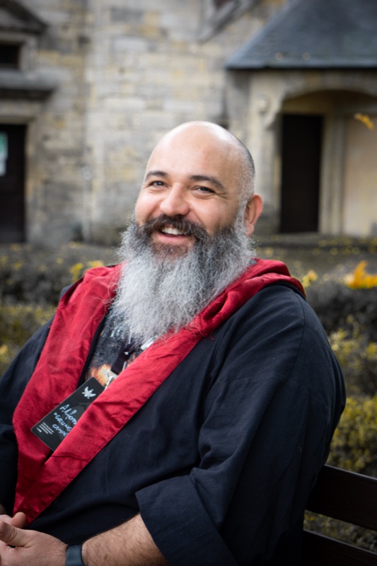 A smiling participant wearing a red scarf