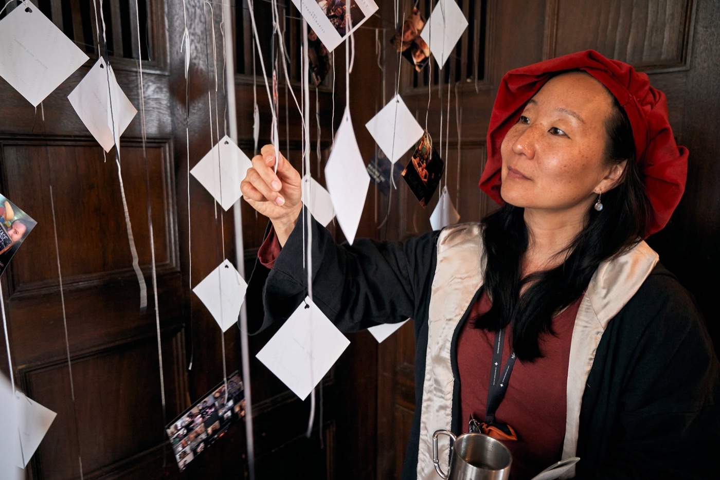 A participant exploring suspended paper cards