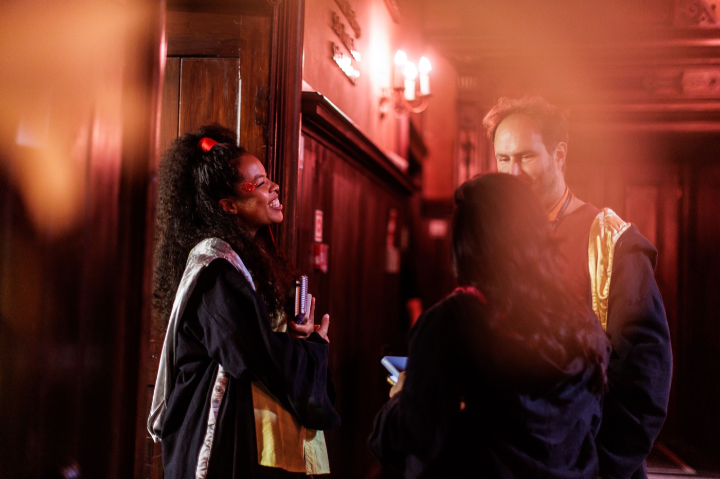 Participants connecting in a warmly lit castle corridor