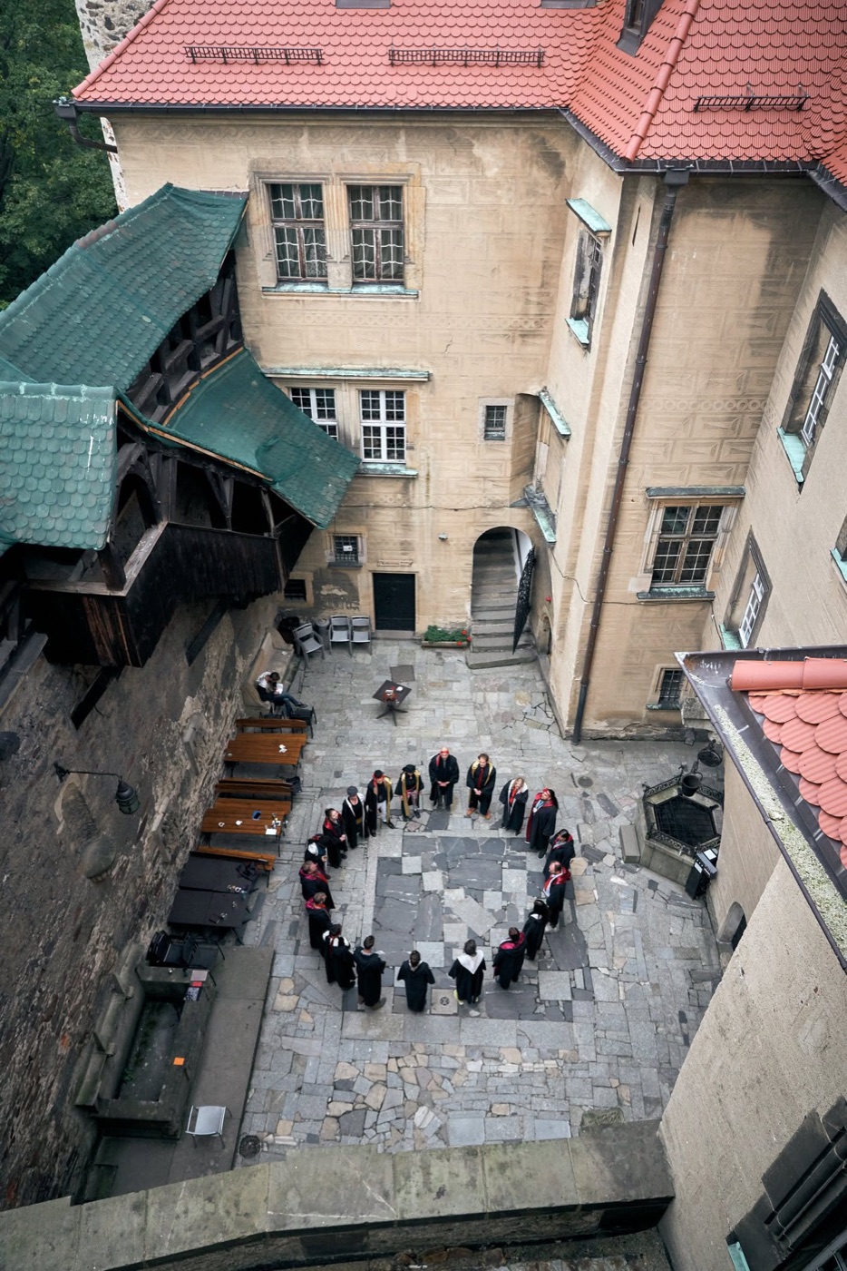 College participants gathered in a circle in the castle courtyard