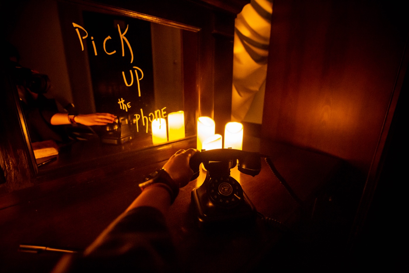 A candlelit telephone inviting participants to pick up the phone